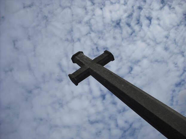 large crucifix under a cloudy sky