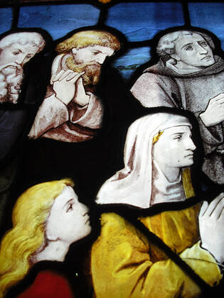 Stain glass window - people praying with solemn faces