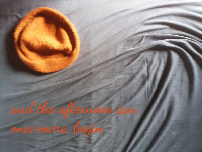 Hazy monk hat on a whirly grey blanket. Text: and the afternoon can, once more, begin